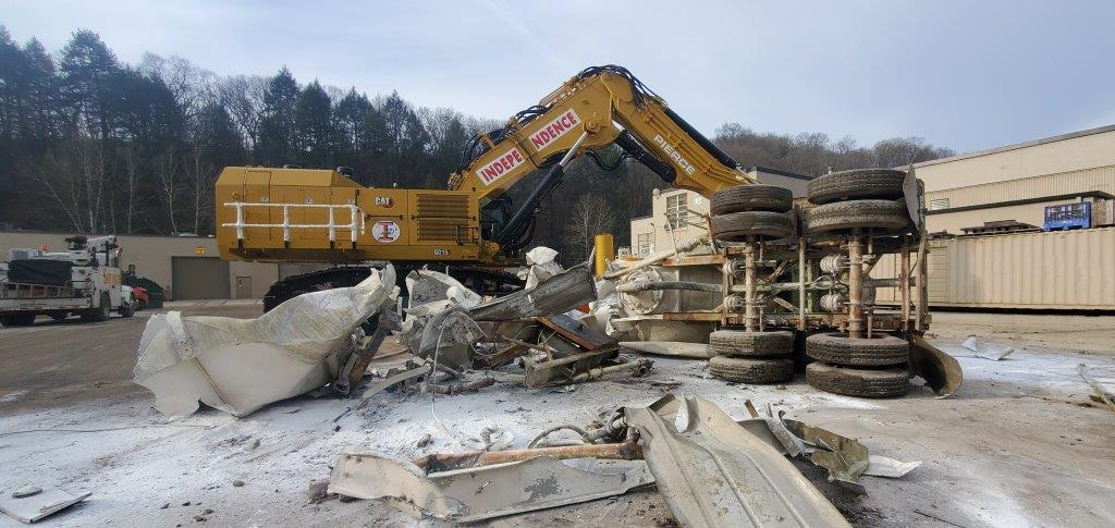  The modified Cat 6015B built by Cleveland Brothers finishes its test run; lifting then demolishing a 2.5-ton concrete trailer.