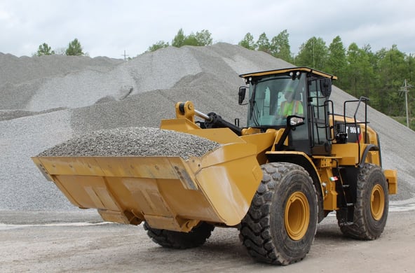 Wheel loader maneuevering gravel
