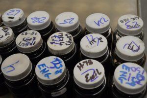 Multiple fluid sample bottles are visible, showcasing how the Cleveland Brothers Fluid Analysis Lab handles 90,000 samples per year.