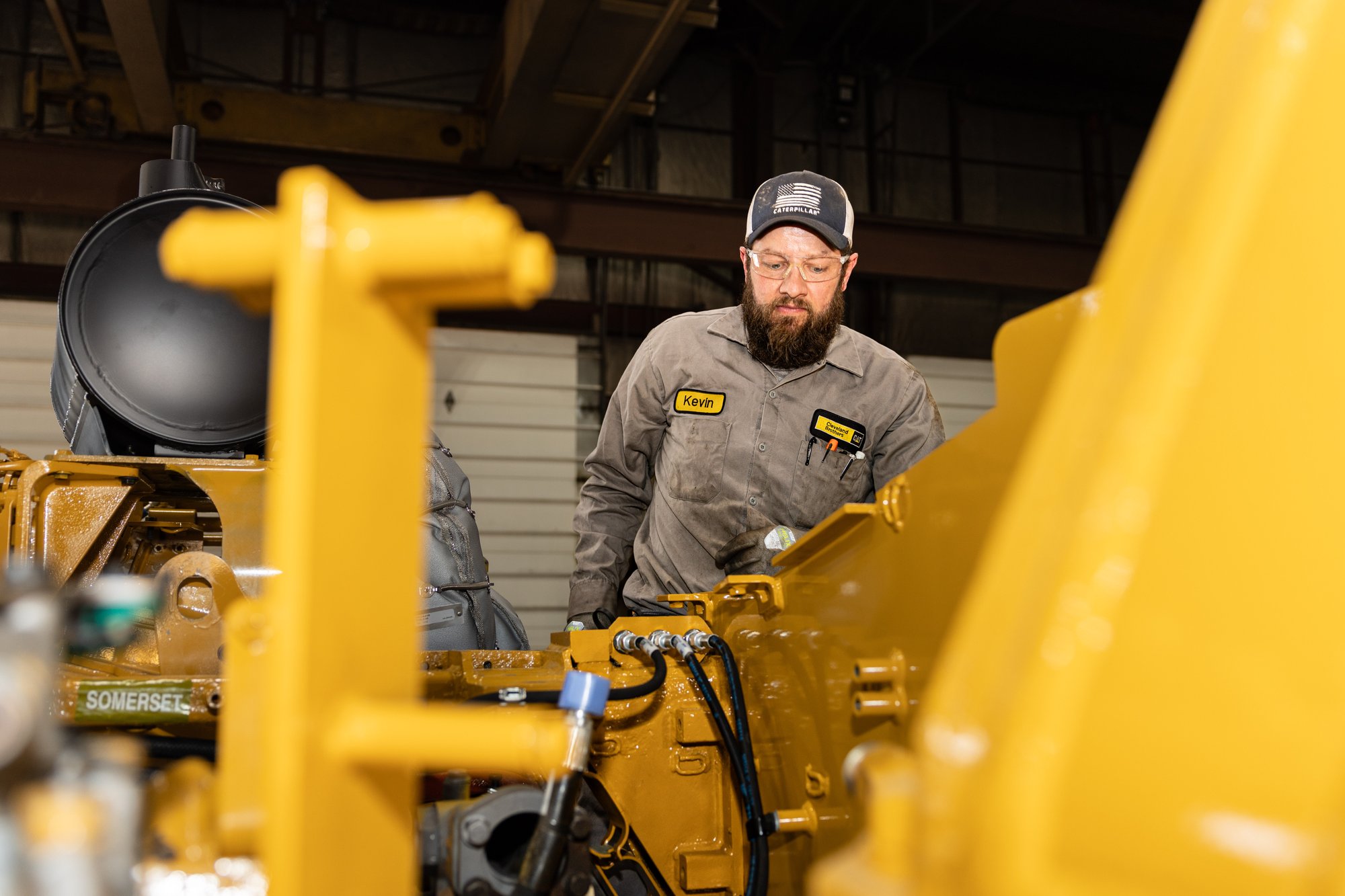 Technician inspecting the interior of heavy equipment during a service check.