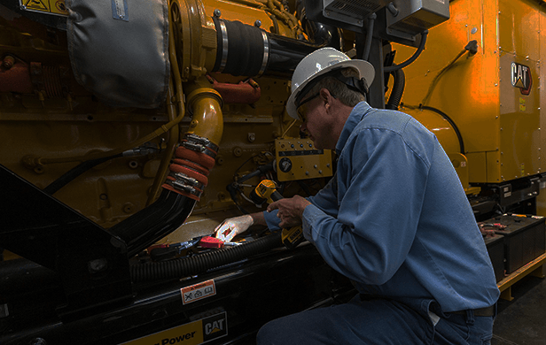 Technician inspecting a generator set