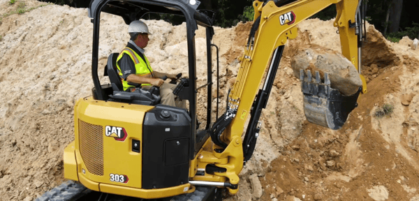 mini-excavator-hardscaping-moving-rock-wide