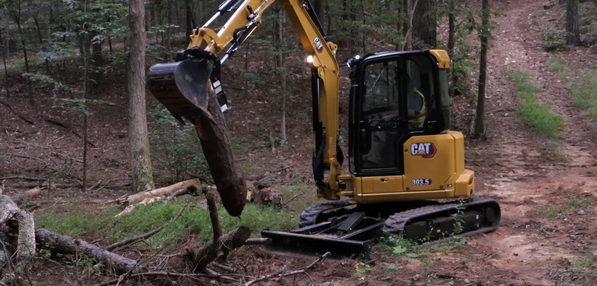 mini-excavator-land-clearing-logs-wide